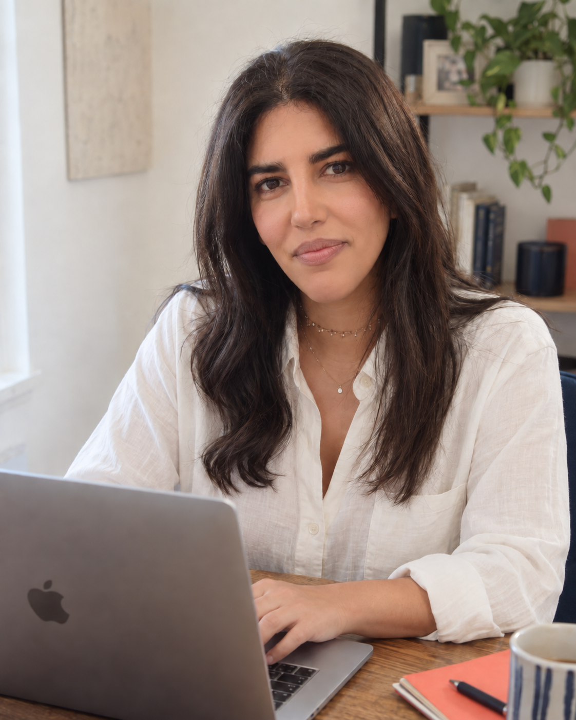 Davina Farahi seated at her laptop